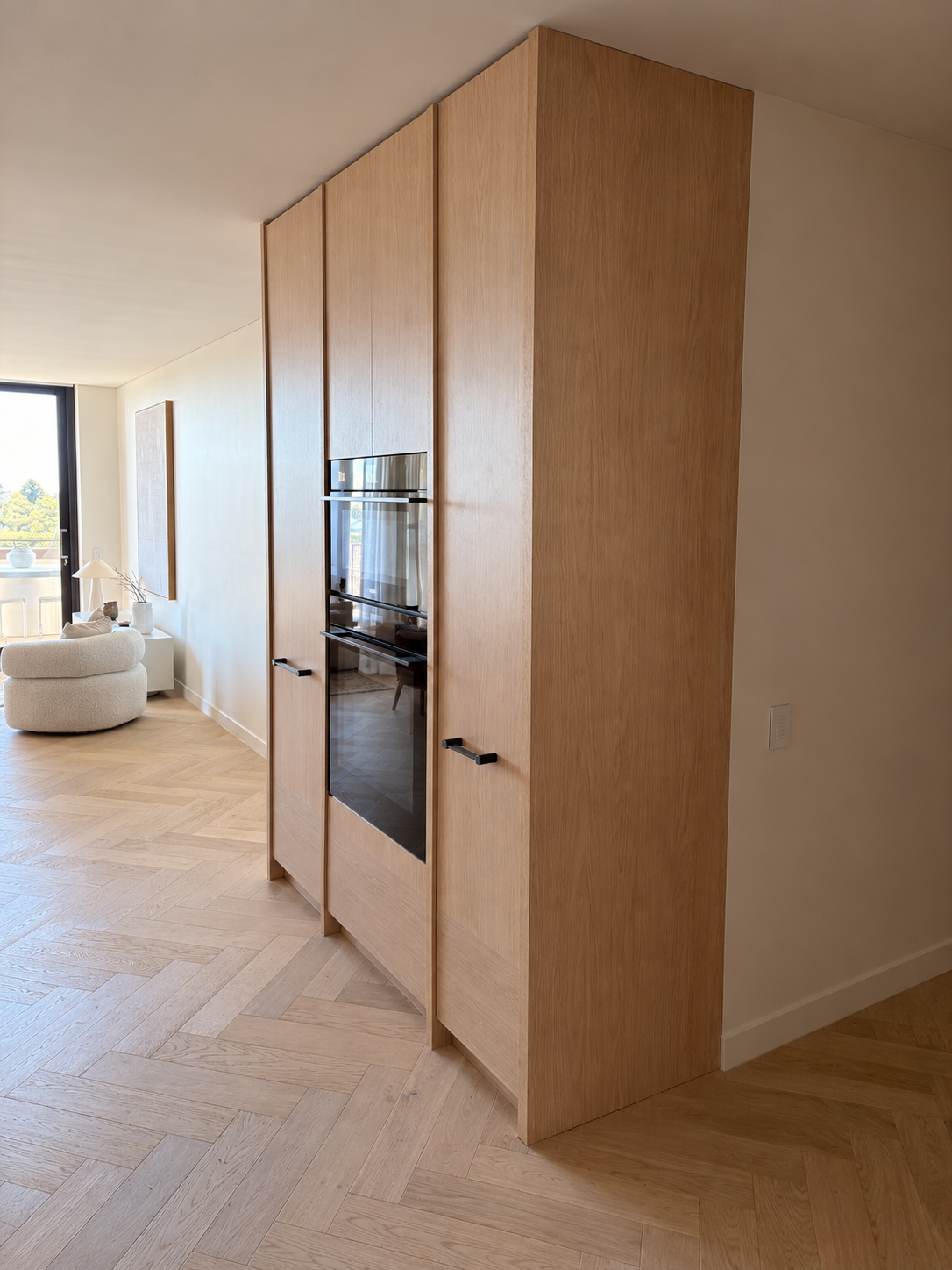 Oak tall cabinetry surrounding built-in appliances