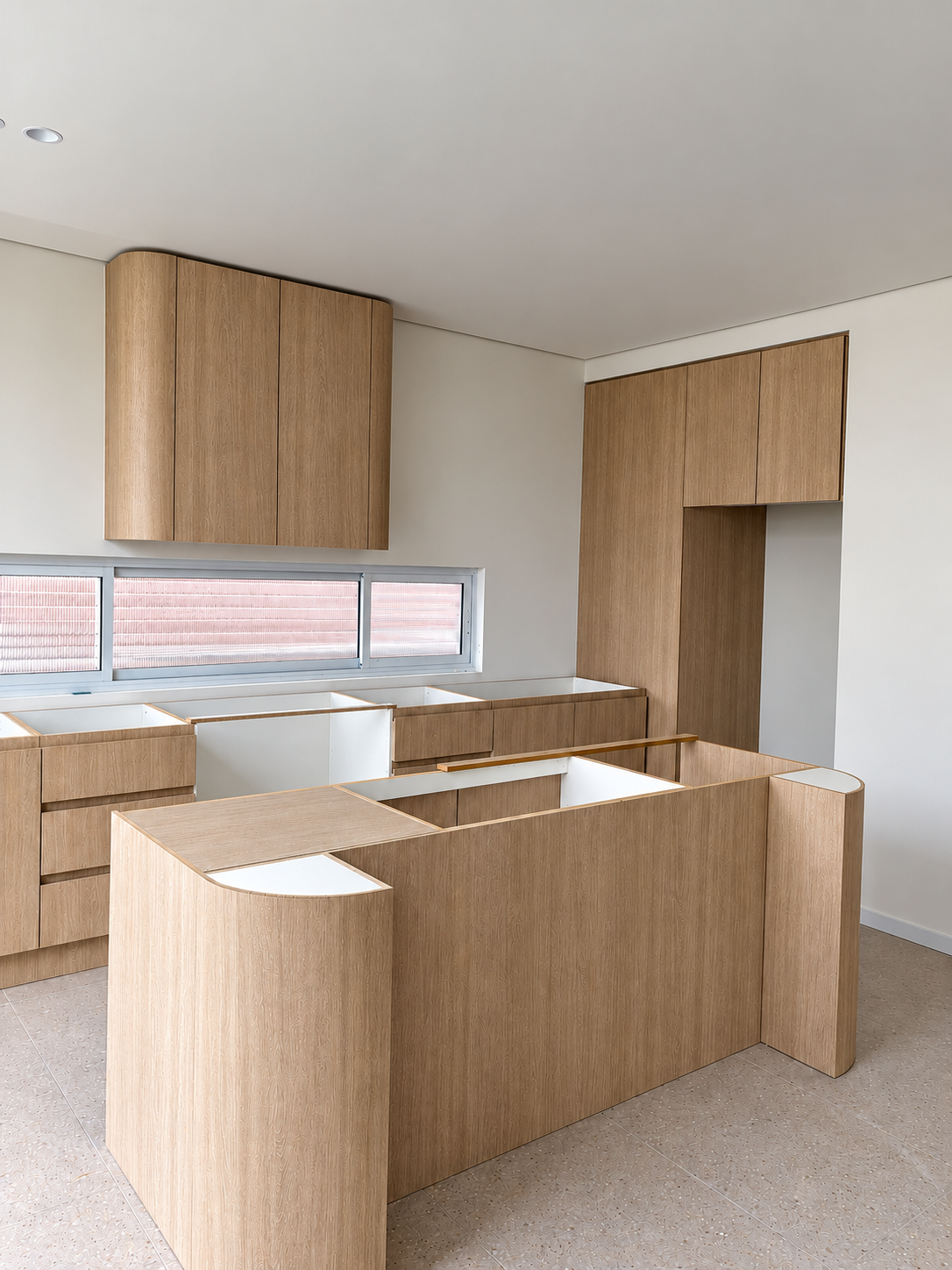 Timber kitchen cabinetry and curved island during installation